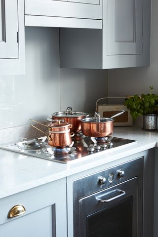 copper pans on hob in Georgian home