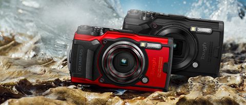 Olympus Tough TG-6 review image of red and black cameras on rock surface surrounded by water