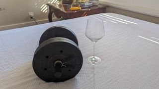 PurpleFlex mattress with weight and wine glass in center