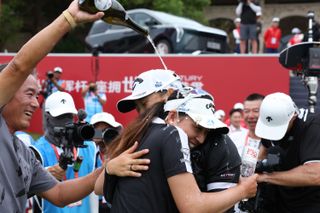 Ruoning Yin gets sprayed with champagne after her victory