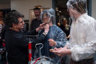 costumer designer danny glicker adjust the costumes on several cast members on the set of saturday night