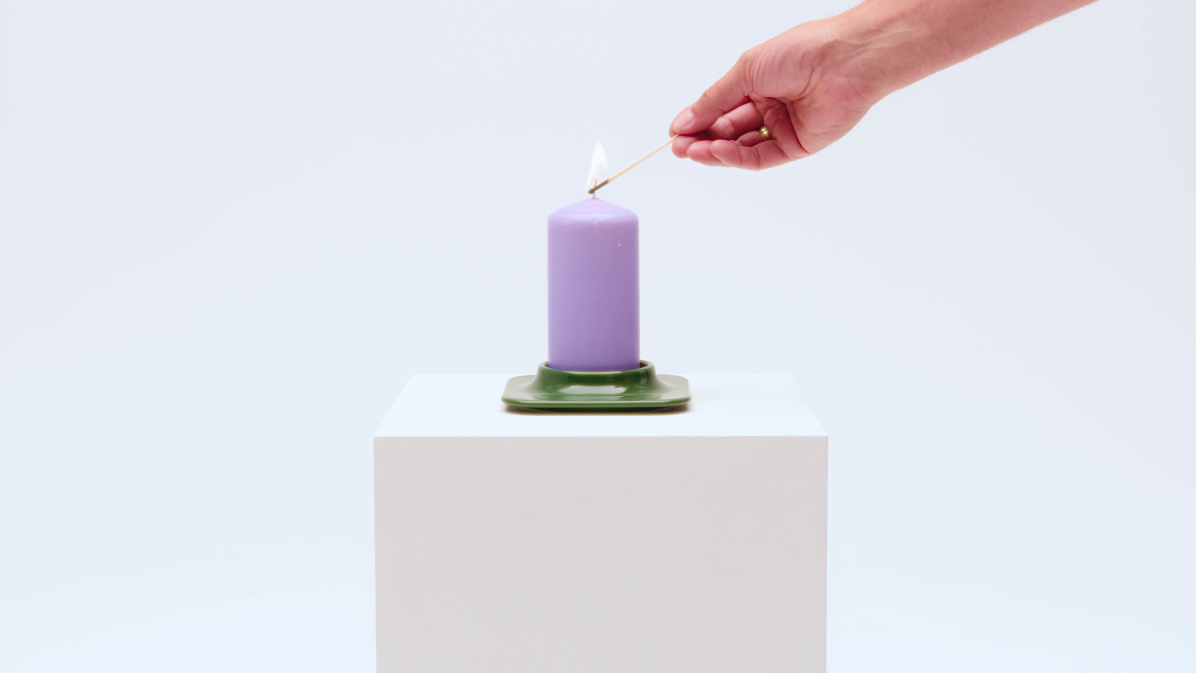 green porcelain candleholder and purple candle