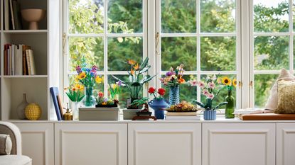 LEGO wildflowers collection in clear vases on windowsill