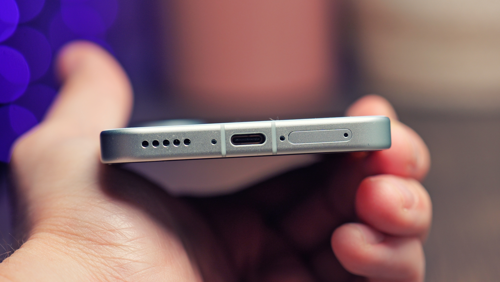 Vivo X200 FE phone held in a hand showing the USB charging port
