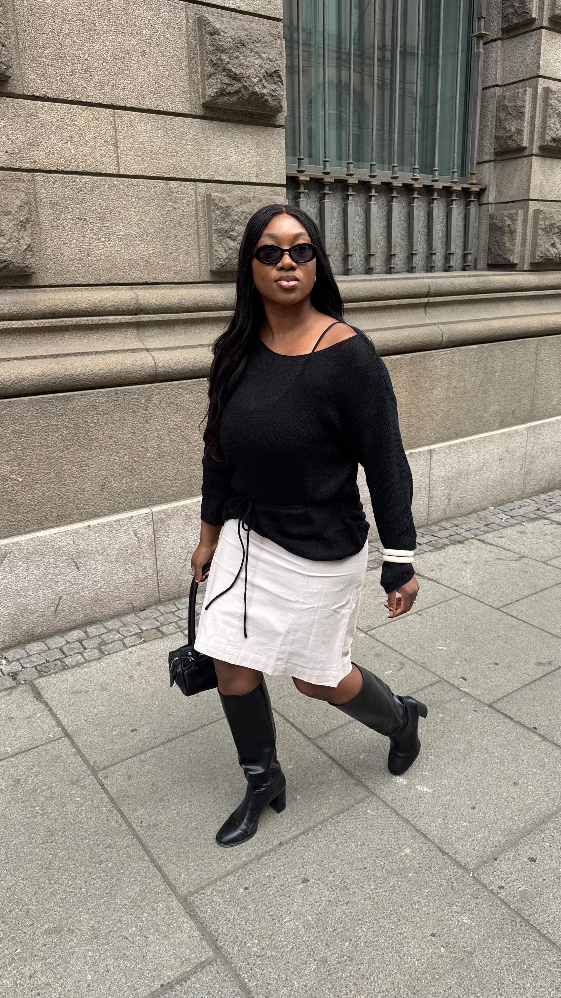 A picture of the best skirts for petites, as styled on @nnennaechem.