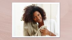 A woman is pictured towel-drying her curly hair whilst looking in the mirror/ in a pink/purple textured template