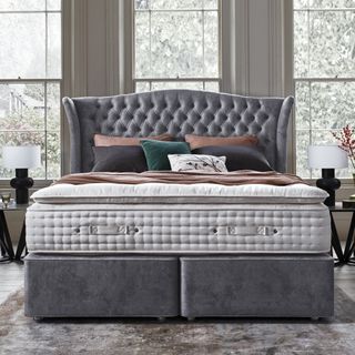 Grey velvet bed base with buttoned headboard and large pocket sprung mattress