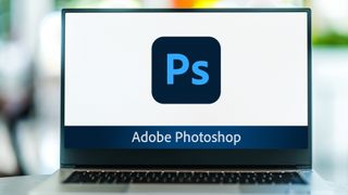 The Adobe Photoshop logo displayed on a laptop screen