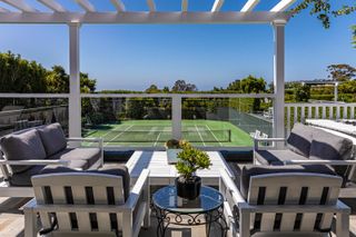 Terrace overlooking tennis court at Rob Lowe's mansion
