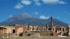 Mount Vesuvius behind the ruins of pompeii.