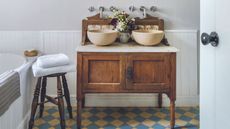 An upcycled wooden bathroom vanity with two sinks