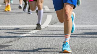 a photo of runners' legs pounding the roads