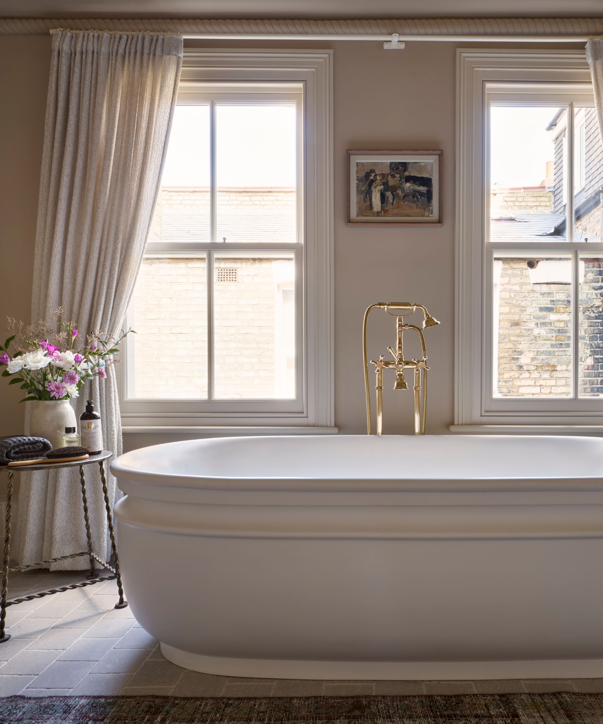 A warm neutral bathroom with wood accents