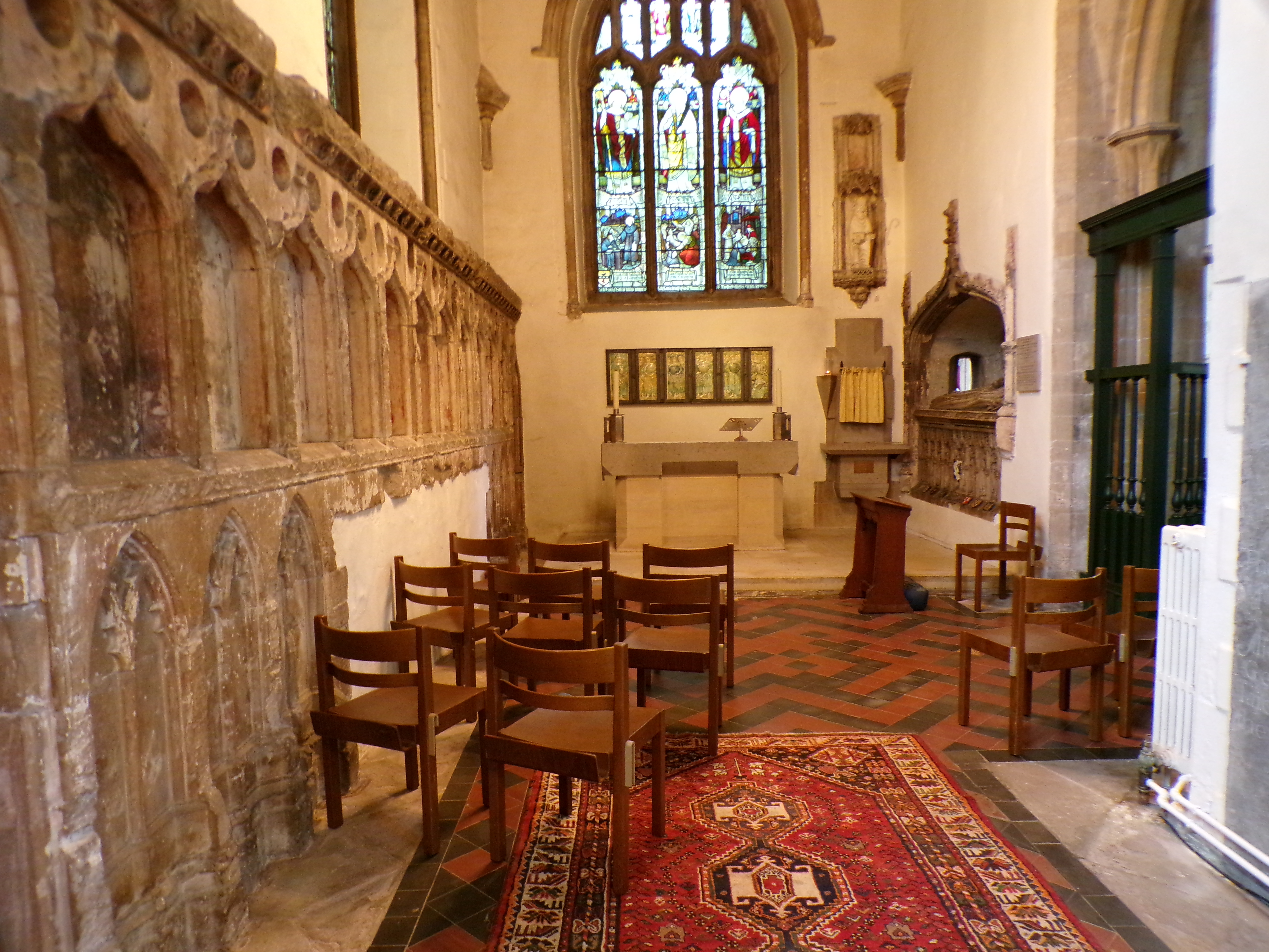 Inside of a large church with stained glass