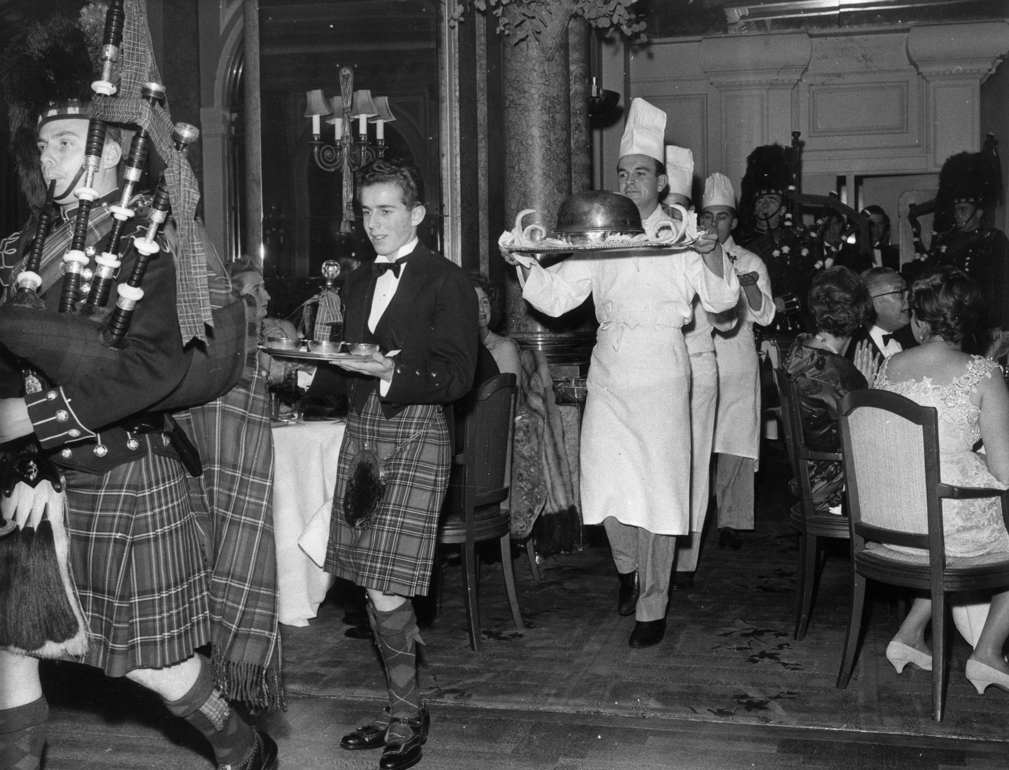 Two men in kilts pipe in a haggis &amp;mdash; carried by a third man in chef whites &amp;mdash; at an annual Burns Night dinner in London
