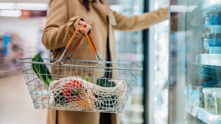 woman grocery shopping with a basket