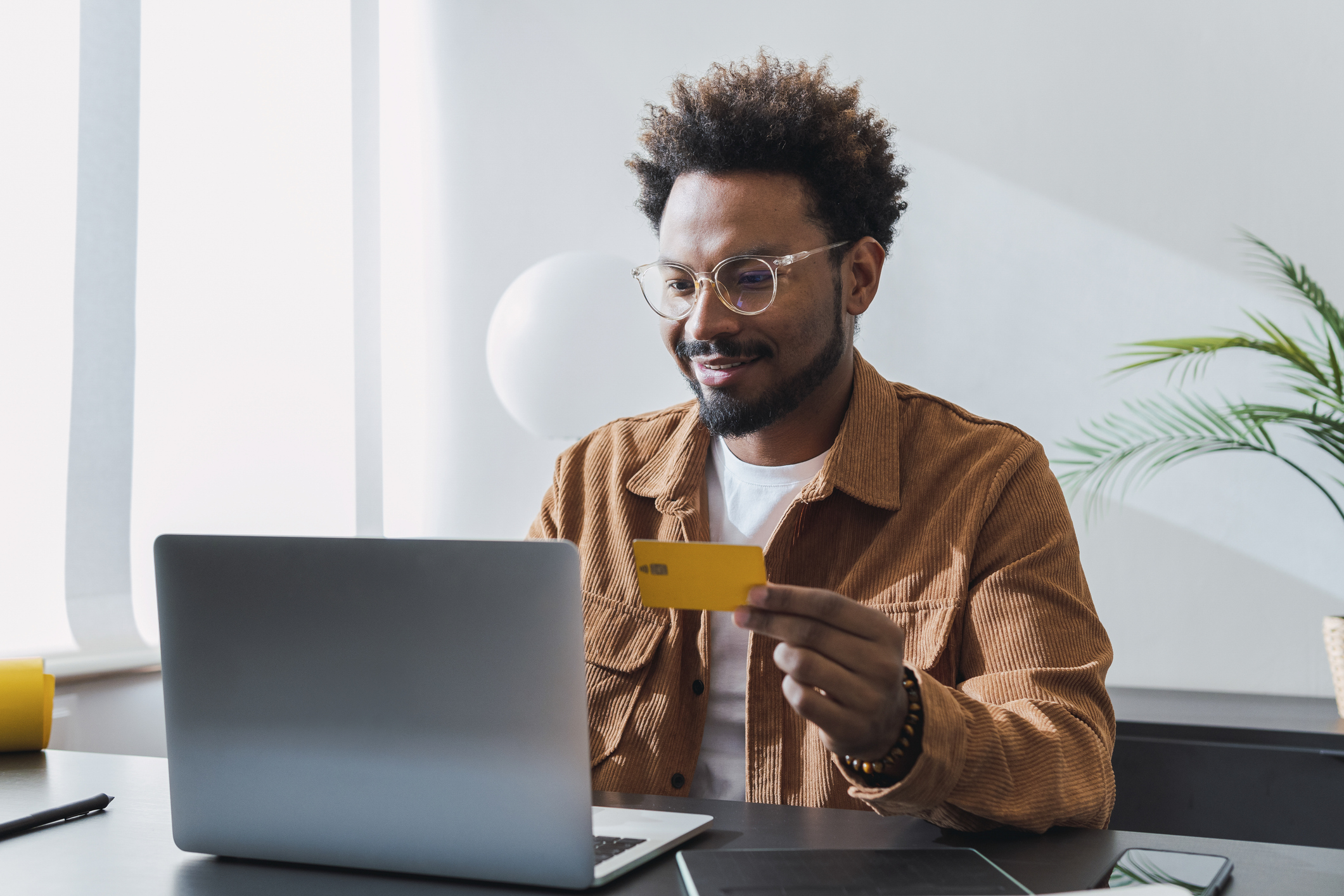 Young man looking at bank switching offers on laptop