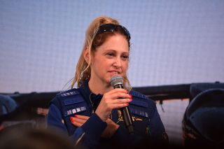 Beth Moses, Virgin Galactic's chief astronaut instructor, places her hand over the inner pocket where she had the flowers she flew into space on the Unity 22 mission on July 11, 2021.