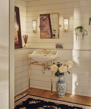 White horizontal bathroom walls, gold taps