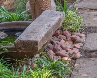 sleeper landscaping around a small water feature