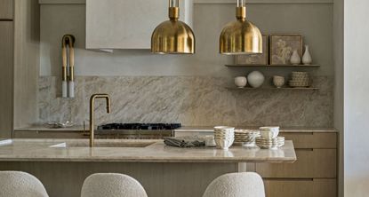 a neutral kitchen with a beige marble backsplash 