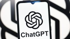 ChatGPT logo and branding pictured on a smartphone screen with logo featured in background.