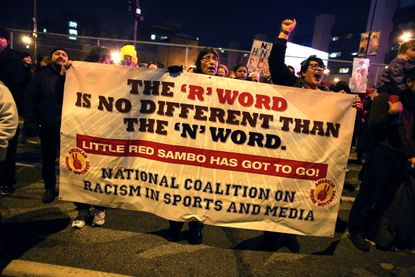 Native Americans protest outside of a Washington Redskins game.