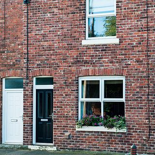 Exterior of red brick terraced houses