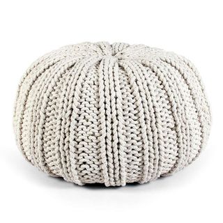A cream white knitted pouffe