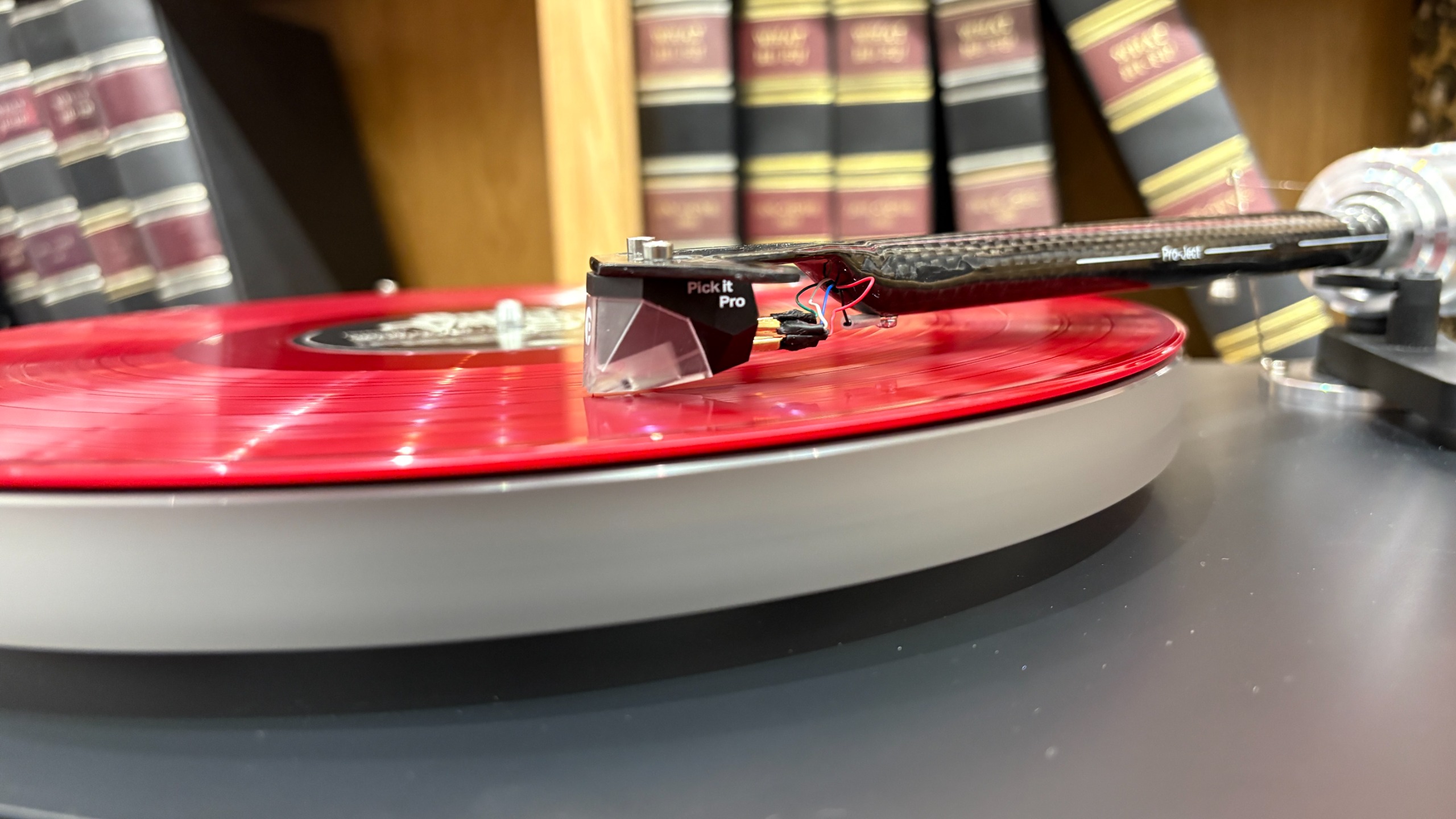 Pro-Ject Debut Reference 10 turntable on wooden shelf
