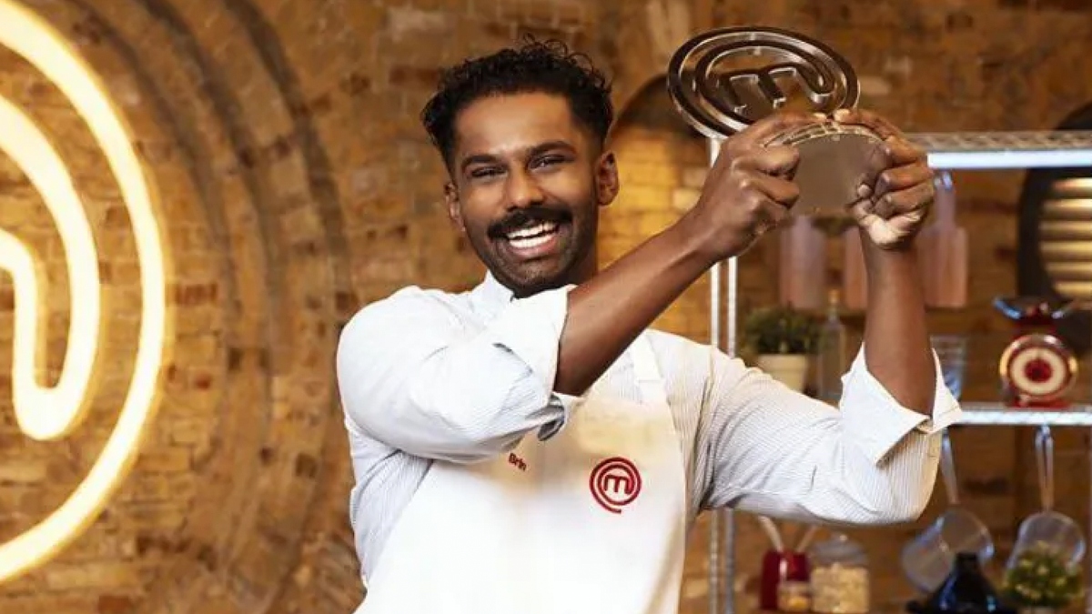 MasterChef 2024 winner Brin Pirathapan holding his award and smiling.
