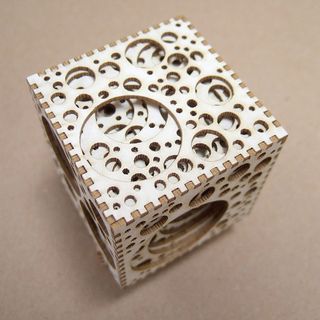 Individual laser cut pieces were hand assembled by computer artist Jarded Tarbell to create this complex geometric shape. Image © Jared Tarbell