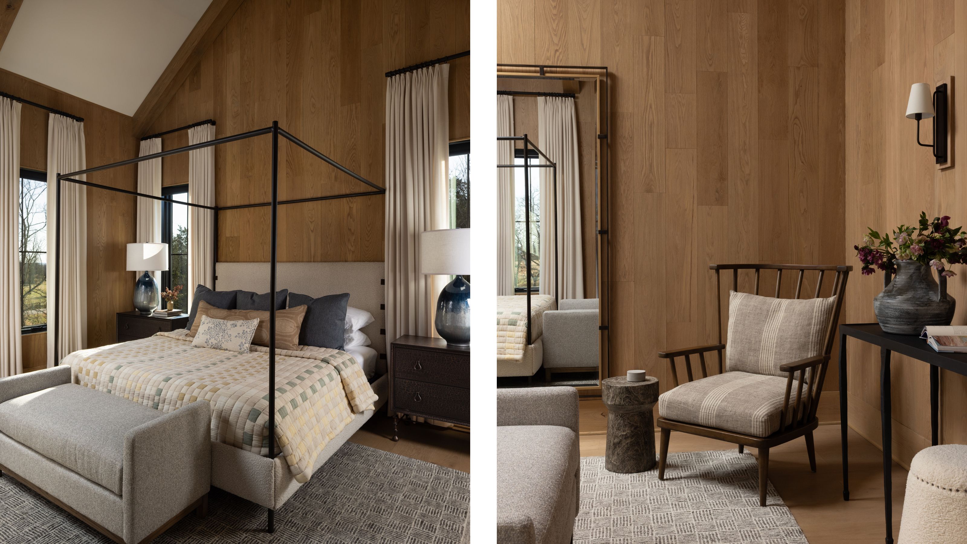 Side-by-side view of a bedroom with warm wood-paneled walls, featuring a black canopy bed on the left and a cozy seating nook with a wooden armchair and floor mirror on the right.