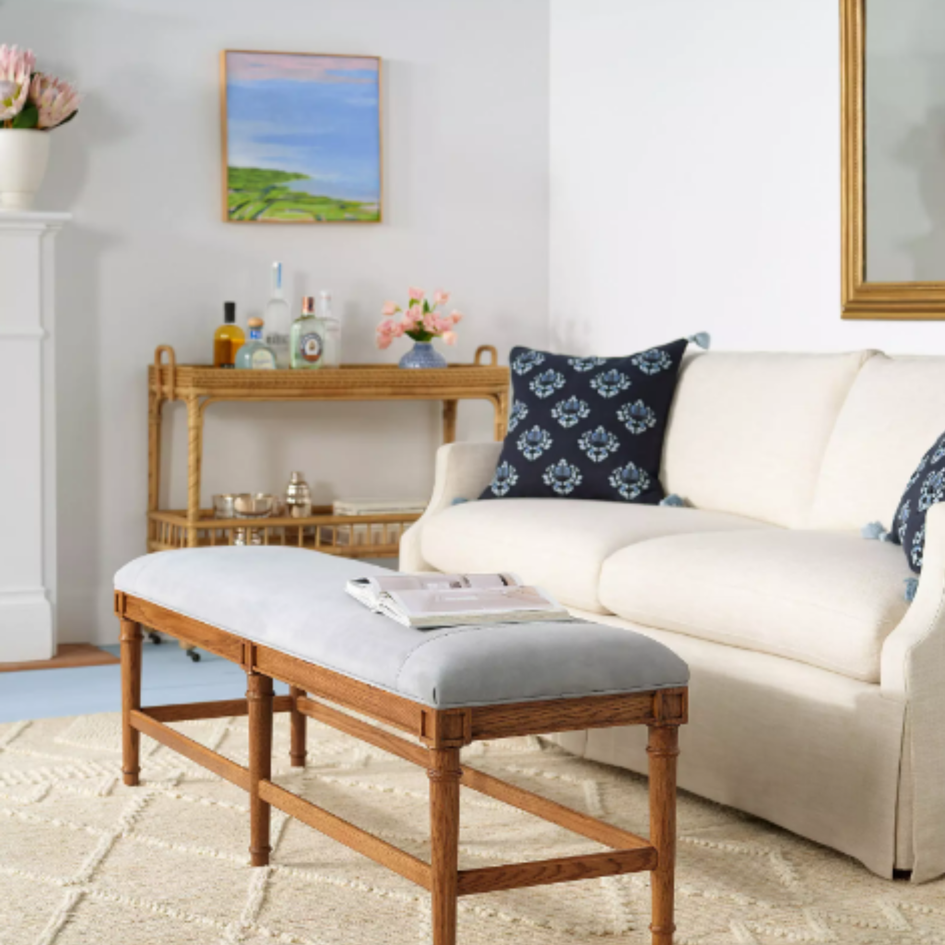A brown and blue bench in front of a sofa