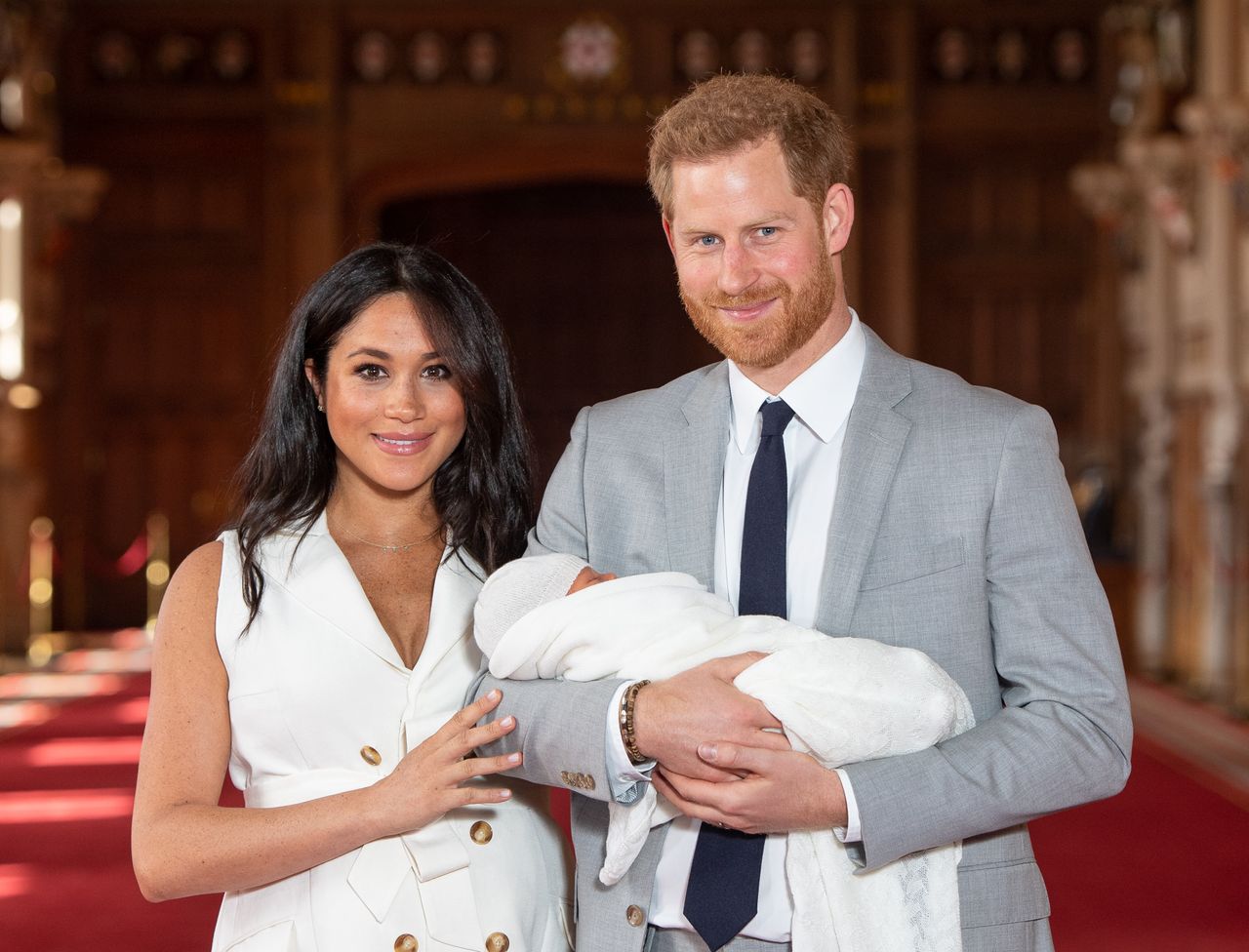 Prince Harry and Meghan Markle, Prince Harry, Duke of Sussex and Meghan, Duchess of Sussex, pose with their newborn son Archie Harrison Mountbatten-Windsor during a photocall in St George&#039;s Hall at Windsor Castle on May 8, 2019 in Windsor