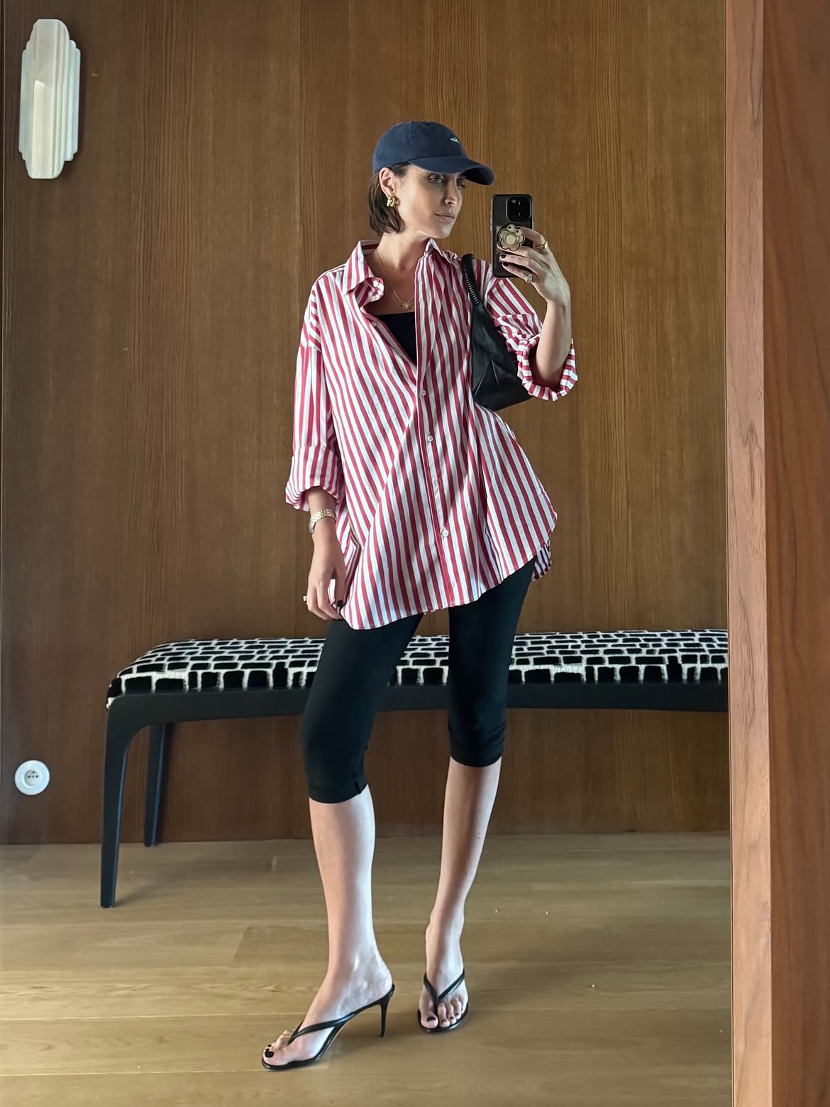 Erin Off Duty wearing a striped button-down shirt with capri pants and heeled thong sandals.