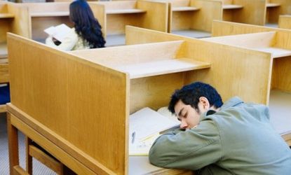 A student takes a nap while studying: The price of a college education has nearly doubled since 1995, far outpacing inflation.