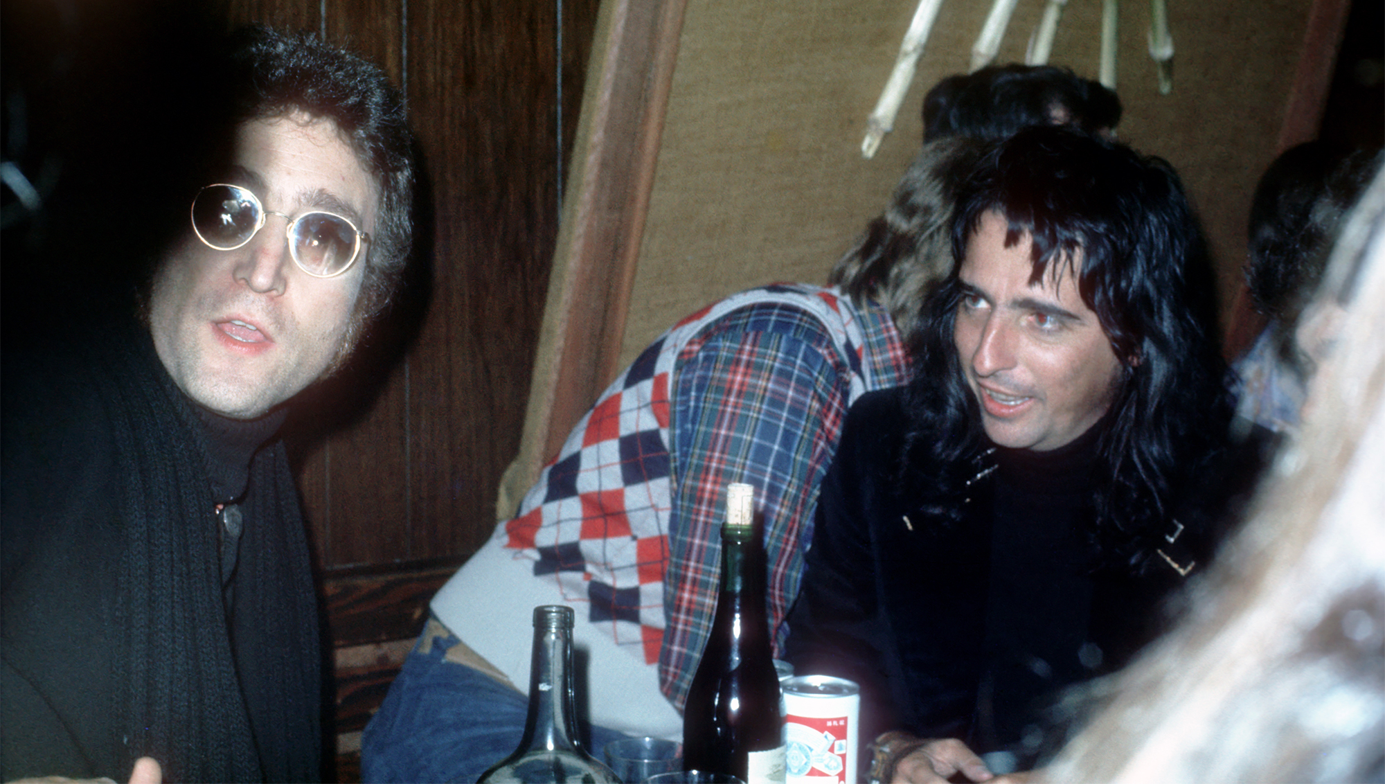 Drinking buddies known as 'The Hollywood Vampires' (L-R - John Lennon (during his 'Lost Weekend' period), Harry Nilsson and Alice Cooper celebrate an early Thanksgiving watching singer Anne Murray at the Troubadour on November 21, 1973 in Los Angeles, California.