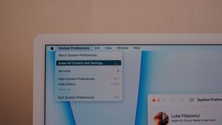 Erase content and settings option in dropdown menu on iMac screen.