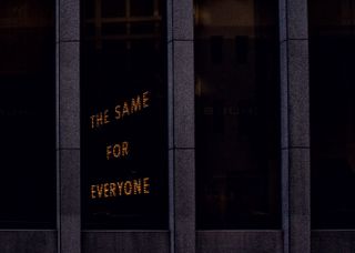 Light up sign writing 'the same for everyone'