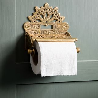 A toilet paper roll on a decorative holder