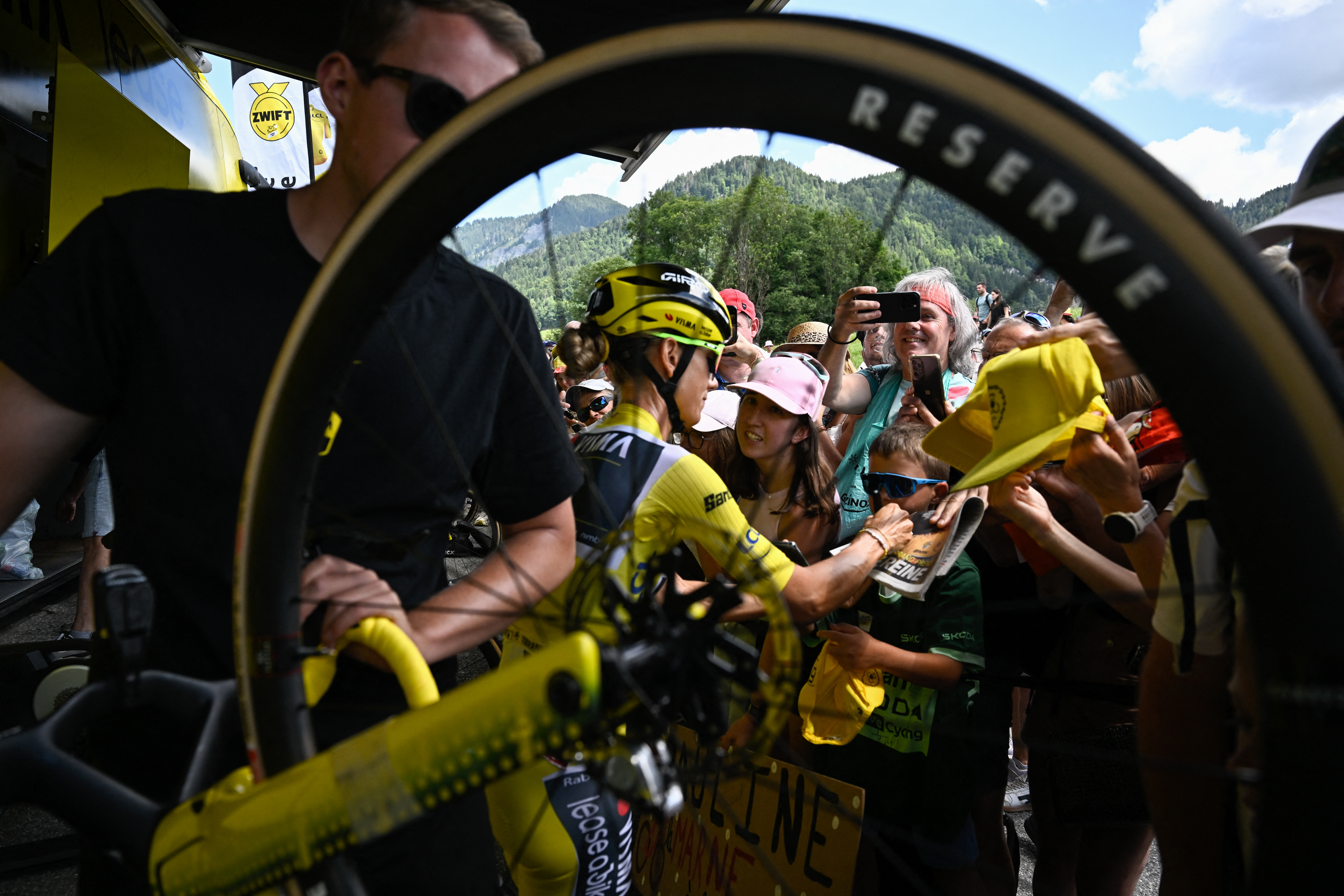 Overall leader's Yellow jersey Team Visma | Lease a Bike's French rider Pauline Ferrand-Prévot signs autographs for fans in front of her team bus, ahead of the start of the 9th and final stage (out of 9) of the fourth edition of the Women's Tour de France
