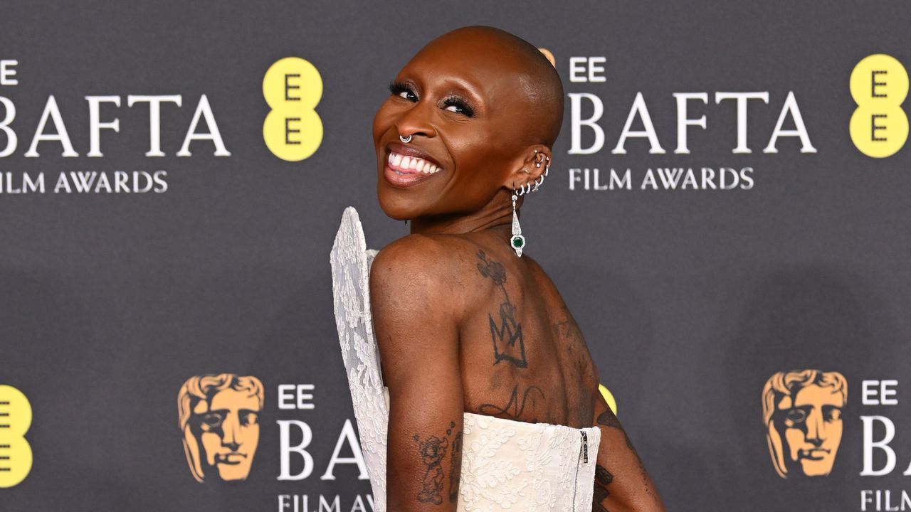 Cynthia Erivo wears a structural white lace gown on the red carpet of the BAFTAs 2025