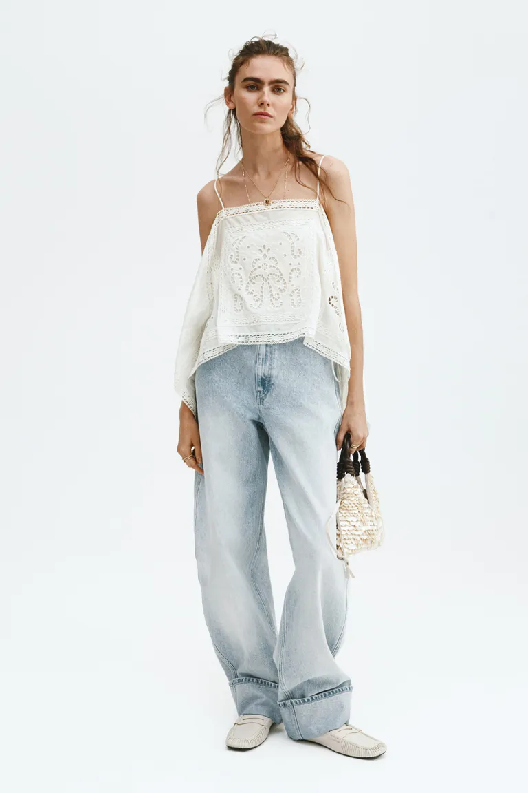 Woman wears pretty blouse, blue jeans and loafers