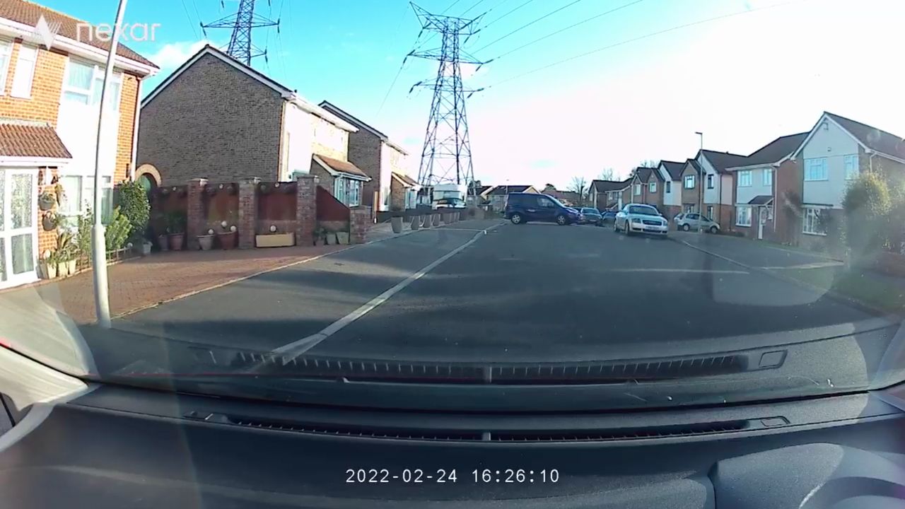 A car dashboard below a view of a road
