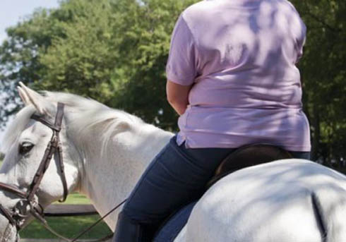 A larger rider pictured from behind