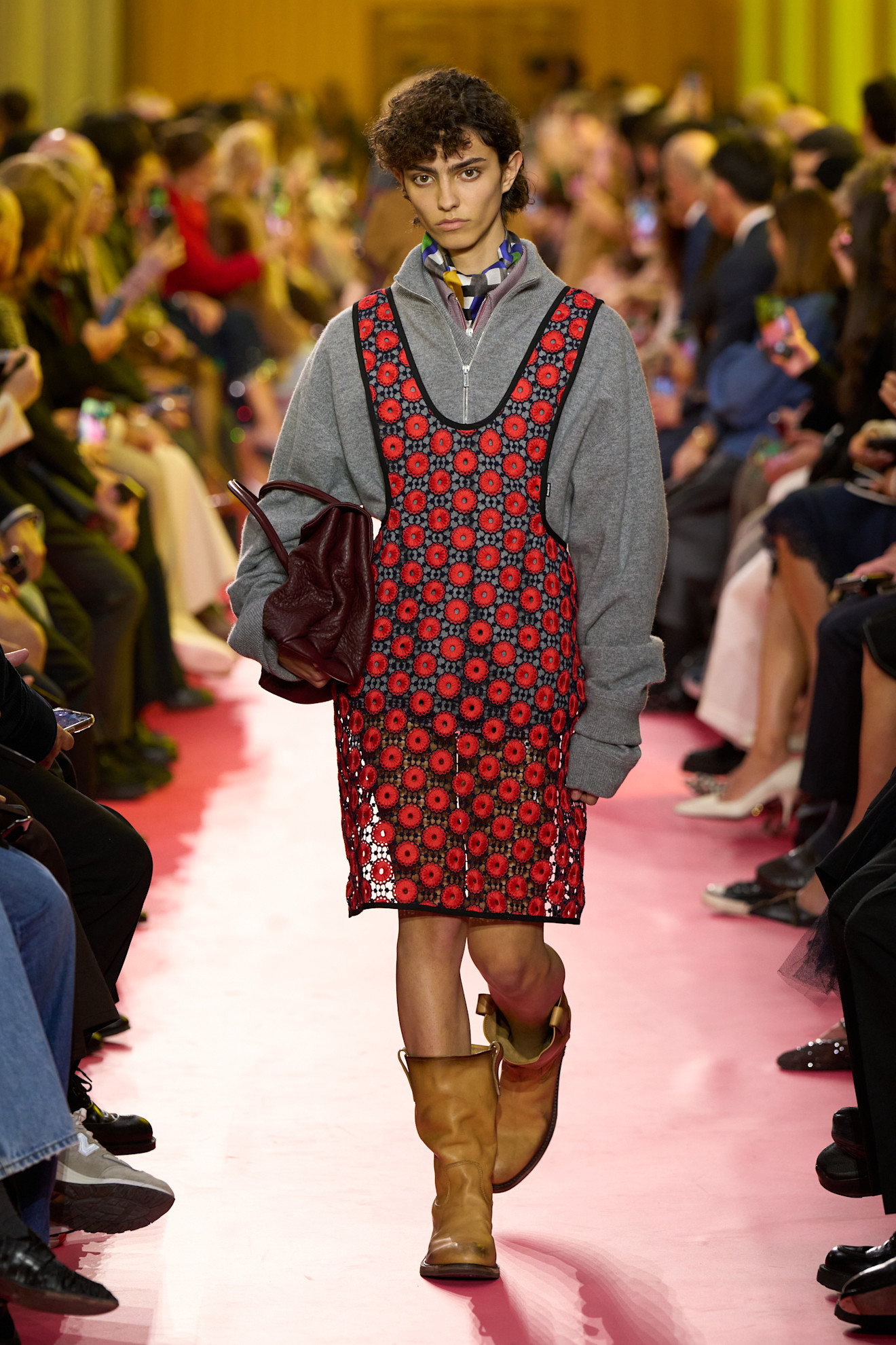 A model wore red-and-gray on the Miu Miu Spring 2026 runway