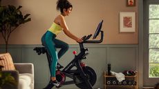 Peloton Bike is one of the best exercise bike being ridden by a woman in a house