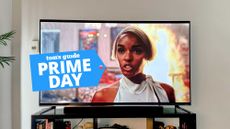 The TCL Q6 QLED television with a woman in a white dress on the screen.