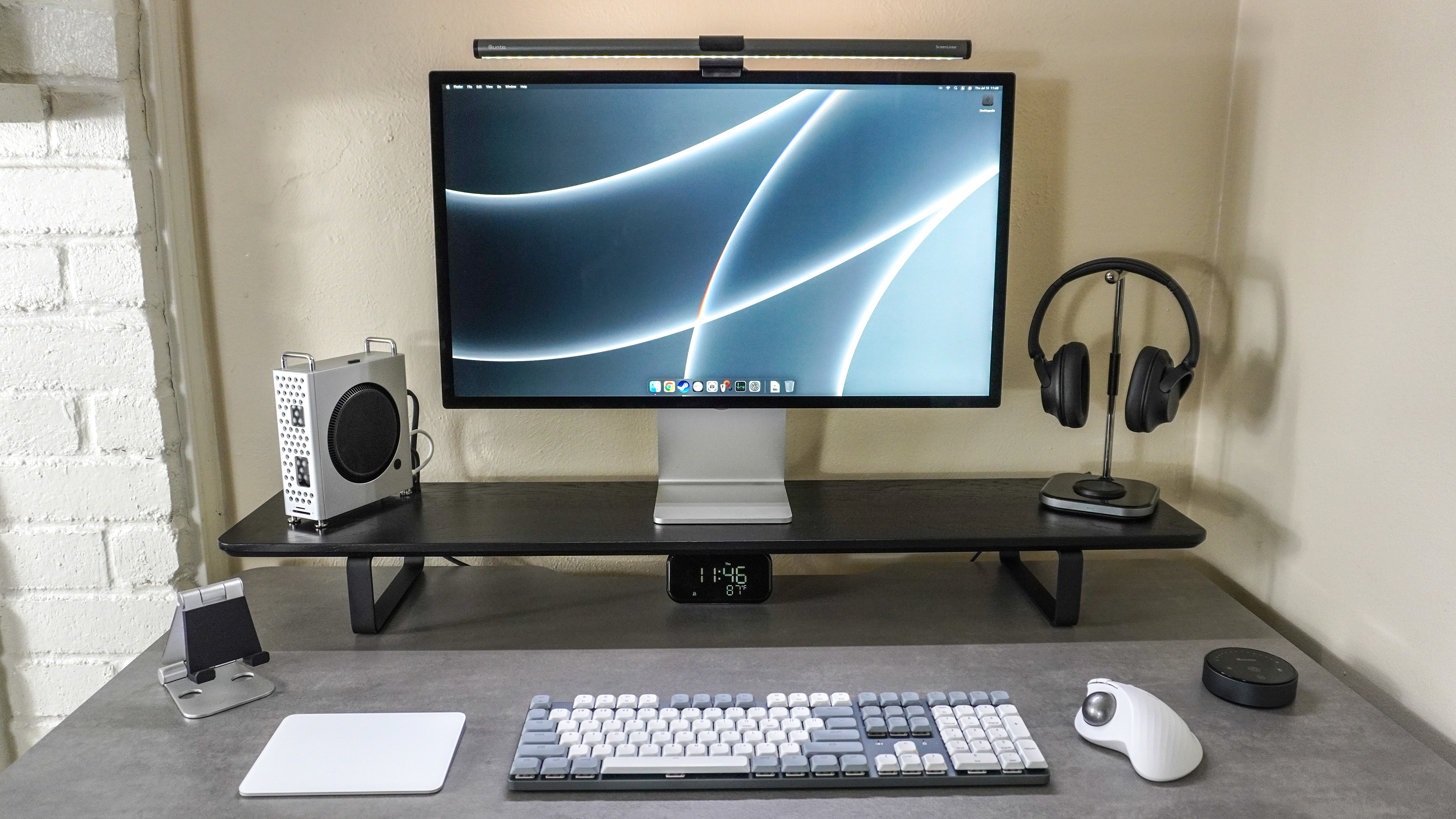 A Mac desk setup with the Mac mini M4 on the left inside the Orico MiniPro Dock Case
